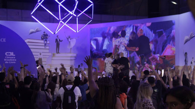 Público levantando as mãos para aparecer em foto tirada na Arena Cultural.