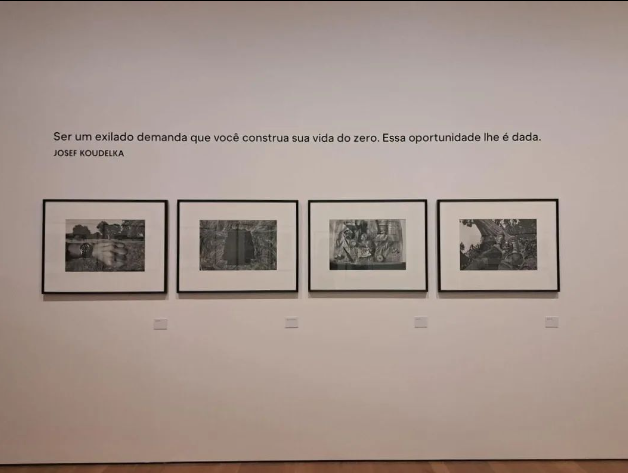 Quadros da exposição de Koudelka embaixo da frase dele "Ser um exilado demanda que você construa sua vida do zero. Essa oportunidade lhe é dada"