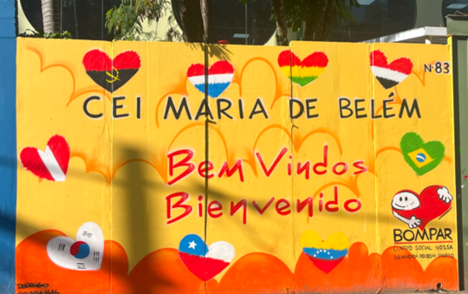 Diversas bandeiras pintadas em formatos de coração em um CEI, refletindo a solidariedade com culturas diversas