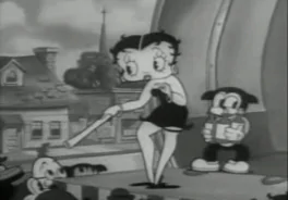 Betty Boop, uma personagem de cabelos curtos e encaracolados, longas pernas e corpo curvilíneo é apresentada em movimento em cima de um palco com um artefato não identificado em suas mãos. Possui maquiagem forte e roupas curtas.