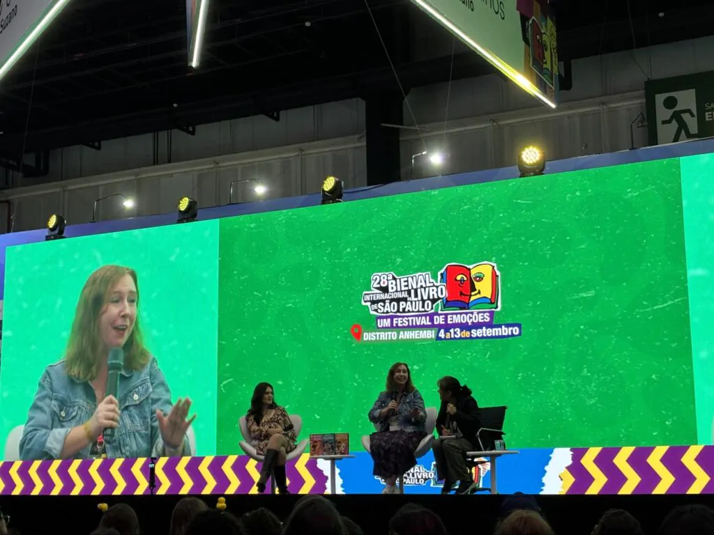 Transmissão ao vivo de palestrante no telão de LED durante painel da Bienal do Livro em São Paulo.